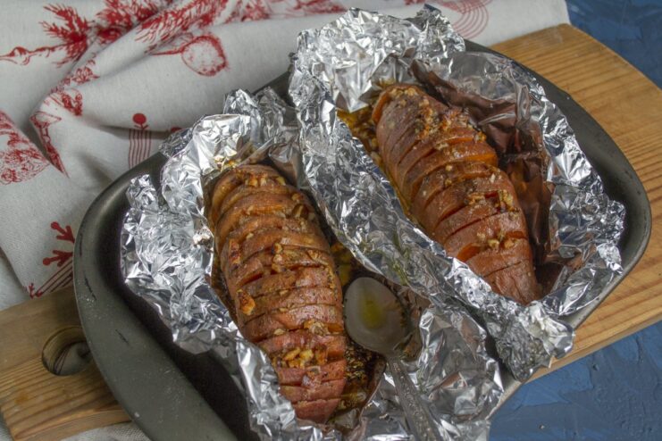 Final Roasting for a Golden-Brown Finish The glazed sweet potatoes on a baking sheet, ready for the final roasting in the oven.