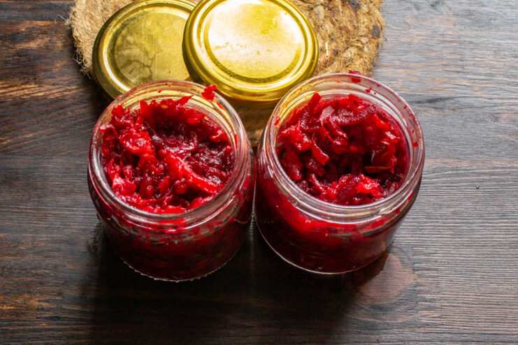Proper storage for your homemade canned borscht dressing. Sealed jars of homemade borscht dressing stored on a shelf in a pantry.