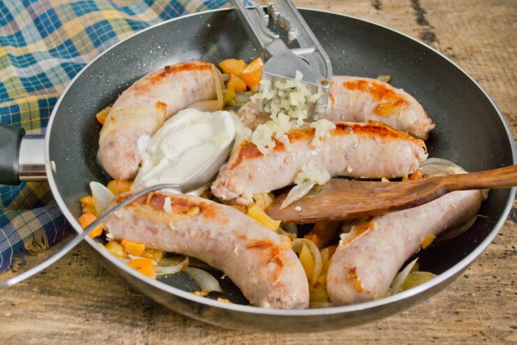 Creating a Rich and Creamy Sauce with Smetana Adding a dollop of smetana or cream to the sausage and vegetables in the skillet.