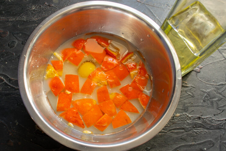 Adding rapeseed (canola) oil to the wet ingredients for a tender crumb. Rapeseed oil being poured into the mixing bowl.