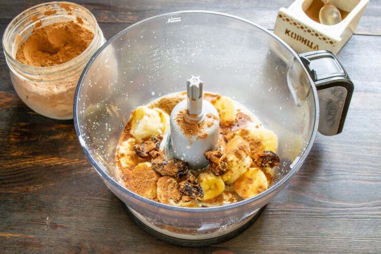 Step 6: Adding Cocoa for a Chocolatey Flavor A teaspoon of unsweetened cocoa powder being added to the blender.