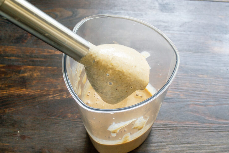 Blending the Smoothie to a Creamy and Airy Texture A creamy peanut banana smoothie being blended until airy.