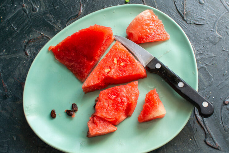 Preparing Watermelon for the Smoothie Cutting the red flesh away from the watermelon rind.