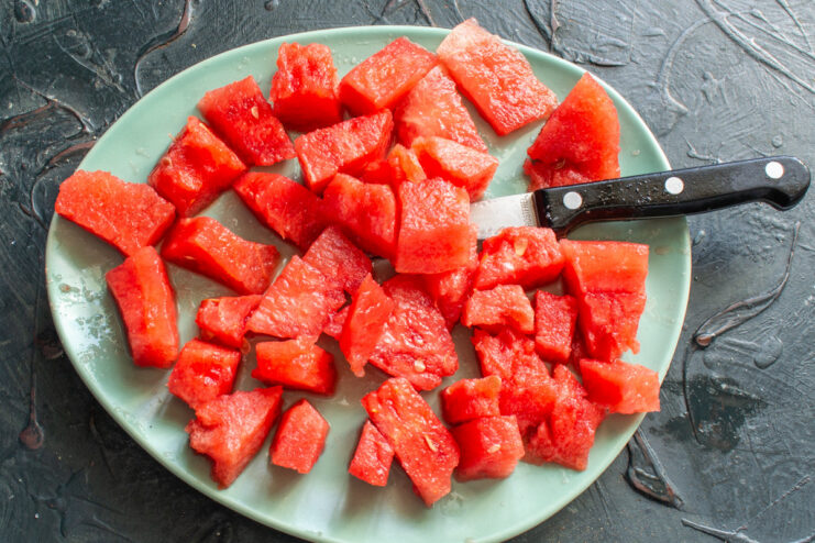 Diced Watermelon Cubes Ready for Freezing Cubes of fresh red watermelon on a plate.