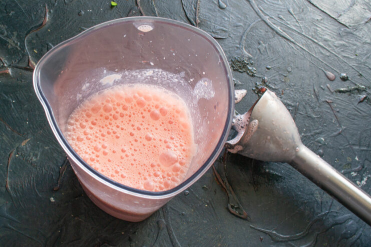Blending Ingredients Until Smooth and Creamy The process of blending the watermelon smoothie to a smooth consistency.