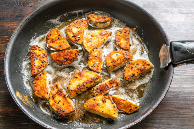 Achieving the Perfect Golden-Brown Crust Eggplant frying in a pan, turning a beautiful golden-brown color.