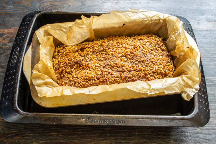 Baking the banana bread in a water bath for extra moisture Loaf pan with banana bread sitting in a larger pan with water, ready for the oven.