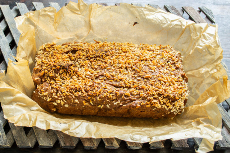 Removing the freshly baked banana bread from the loaf pan A golden-brown, freshly baked loaf of gluten-free banana bread.