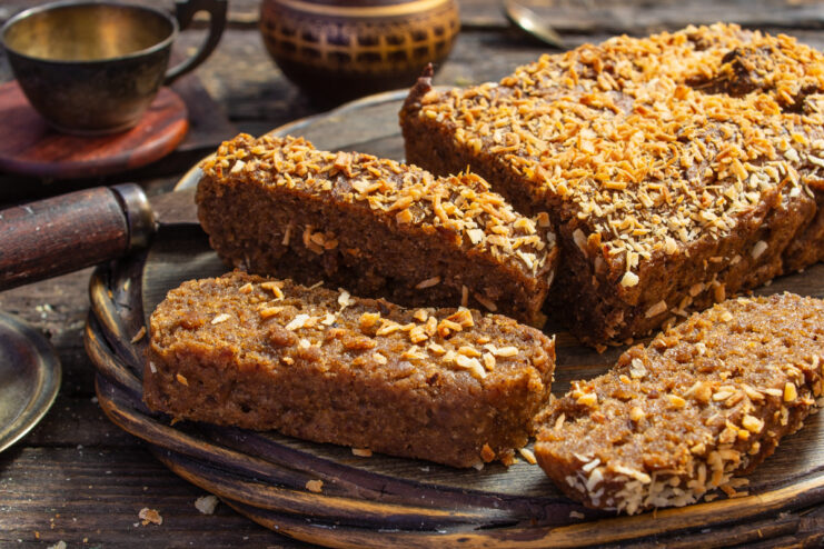 A slice of moist gluten-free banana bread served on a white plate.