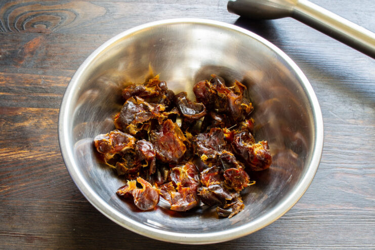 Preparing dates by pitting and soaking them in water Pitted dates soaking in a bowl of water.