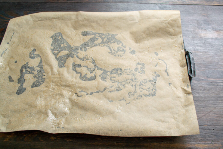 Preparing the Baking Tray for the Sponge Roll A baking tray lined with a sheet of parchment paper, ready for the batter.