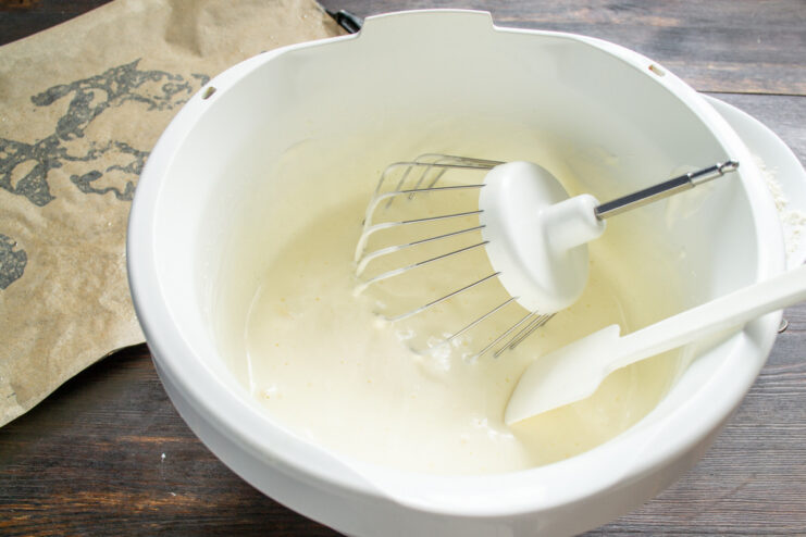 Starting the Sponge Batter with Eggs and Sugar Eggs and sugar in a glass mixer bowl before whipping.