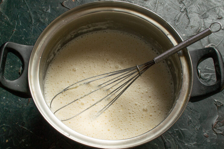 Mixing the Batter Until Smooth Whisking the blinchiki batter in a bowl to remove any lumps.