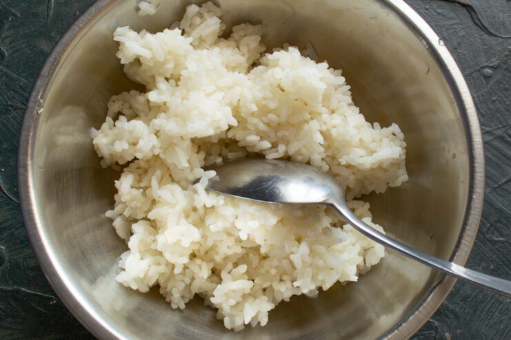 Cooking rice for the blinchiki filling A pot of rice cooking on the stove.