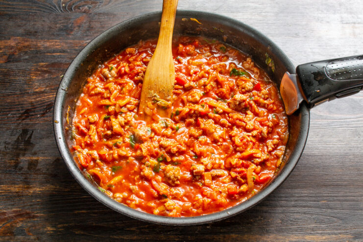 Simmering the Meat Sauce to Perfection The meat and vegetable sauce simmering gently in a frying pan.