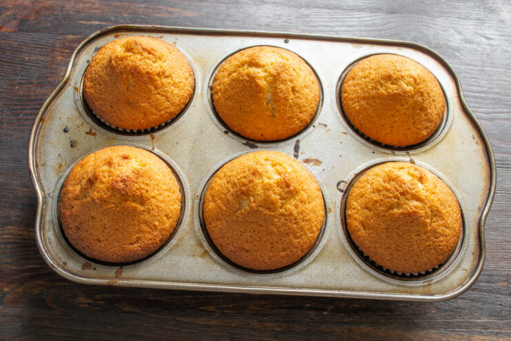 Step 8: Baking the apple cider cinnamon buns. A muffin tin with unbaked cinnamon buns ready to go into the oven.