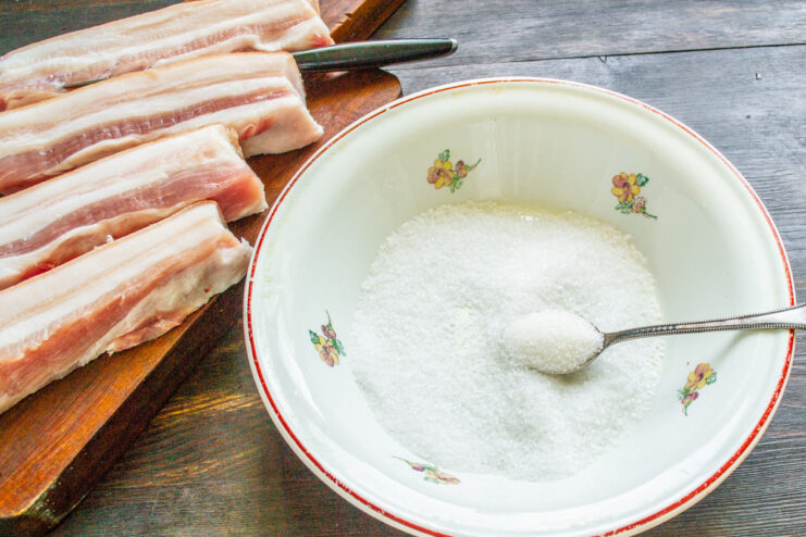 The key to curing: Using coarse sea salt for the best flavor. A bowl filled with coarse sea salt for curing pork belly.
