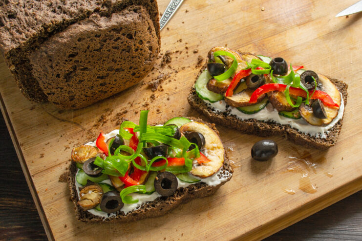 Final Garnish with Fresh Green Onions Decorating the finished mushroom sandwiches with fresh, curled green onion strips.