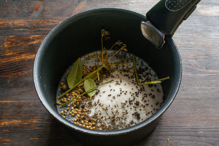 Aromatic Spices for Pickling: Dill Umbels and Bay Leaves Spices for pickling, including dill umbels and bay leaves, in a saucepan.