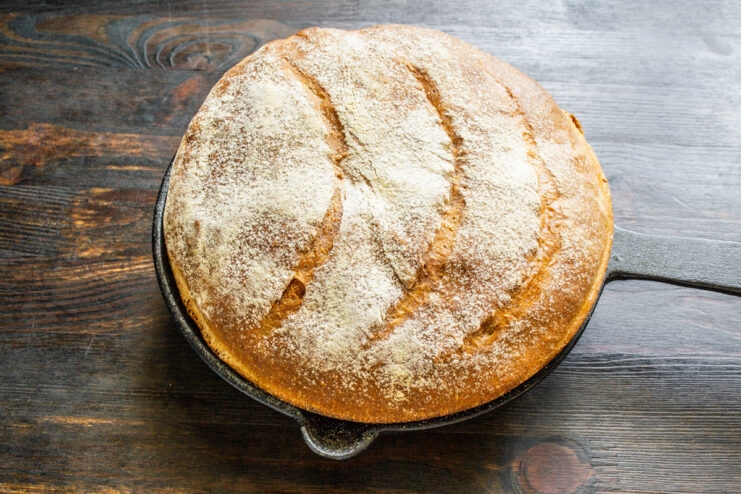 Making diagonal cuts on the top of the proofed sourdough loaf before baking.