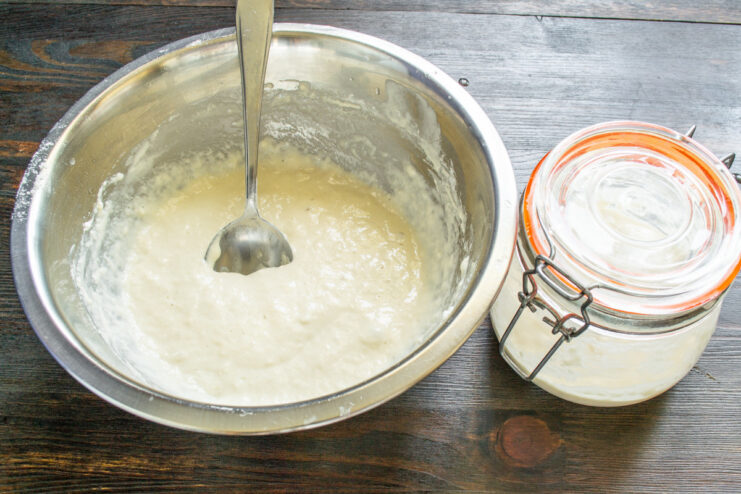 Adding 70 grams of first-grade wheat flour to the starter and water mixture.