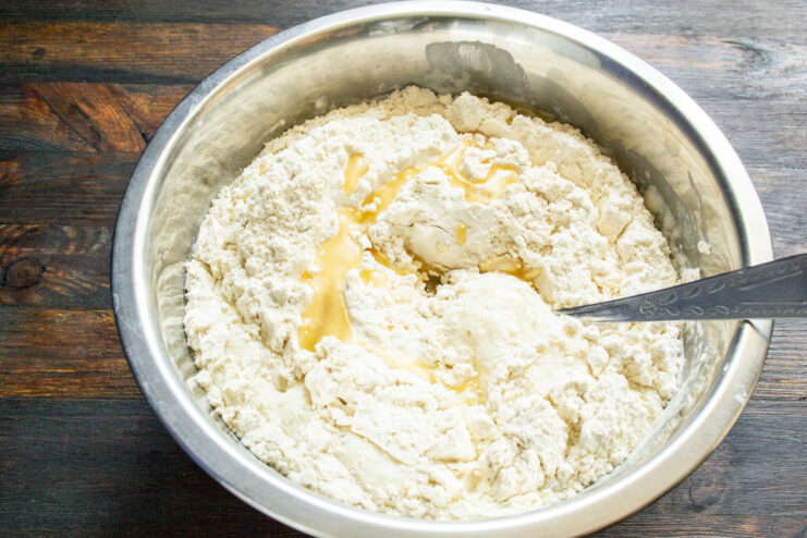All bread ingredients—leaven, flour, honey water, and butter—combined in a bowl.