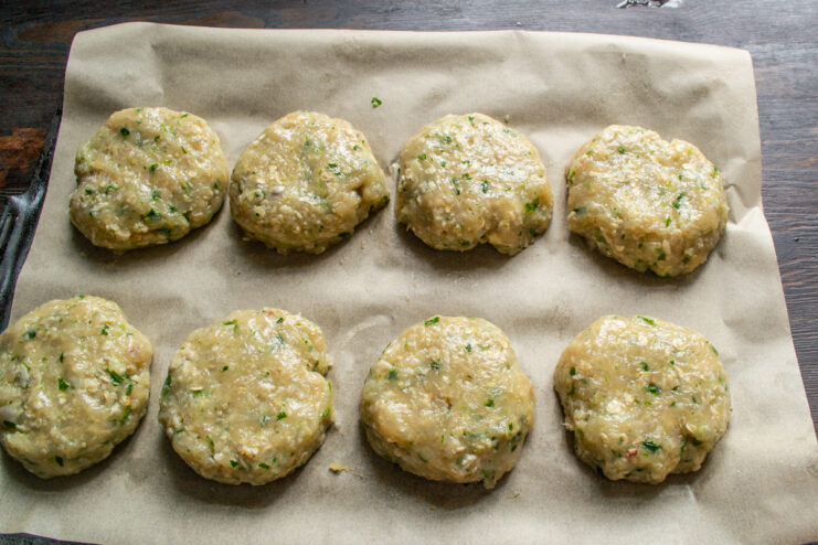 Step 6: Shaping and arranging the cutlets for baking Raw, shaped chicken cutlets arranged on a parchment-lined baking sheet.