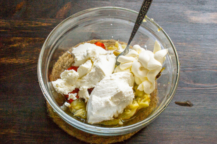 Adding Ricotta and Smetana for Creaminess Adding scoops of ricotta cheese and smetana (sour cream) to the bowl of mashed roasted vegetables.
