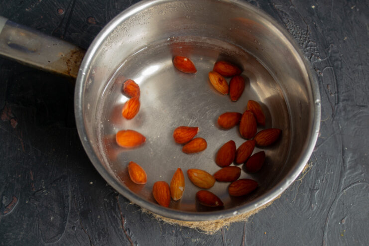 How to Easily Peel Almonds for a Recipe A pot of boiling water with almonds being blanched to remove their skins.