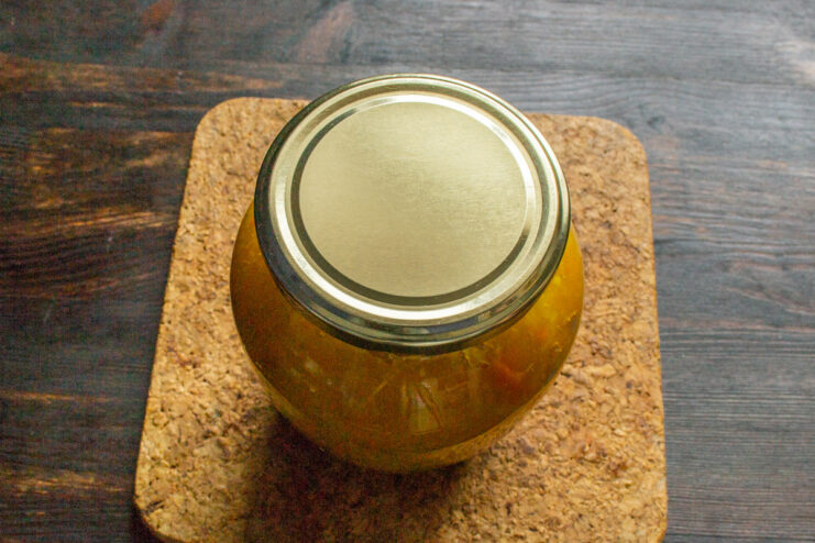 Sealing the jam jars for long-term storage A sealed glass jar of pumpkin jam, with a metal lid tightly screwed on.
