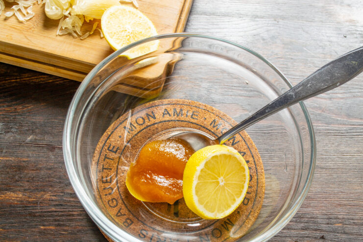 Making a simple honey-lemon dressing for fruit salad A small bowl with honey and lemon juice, ready to be mixed for the dressing.