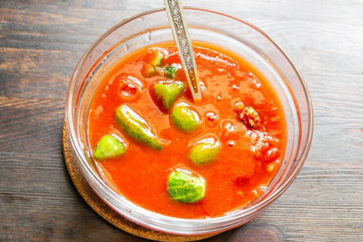 Pro Tip: Use Tomato Juice Instead of Water for a Richer Gazpacho Pouring tomato juice into a bowl with other gazpacho ingredients for a richer flavor.