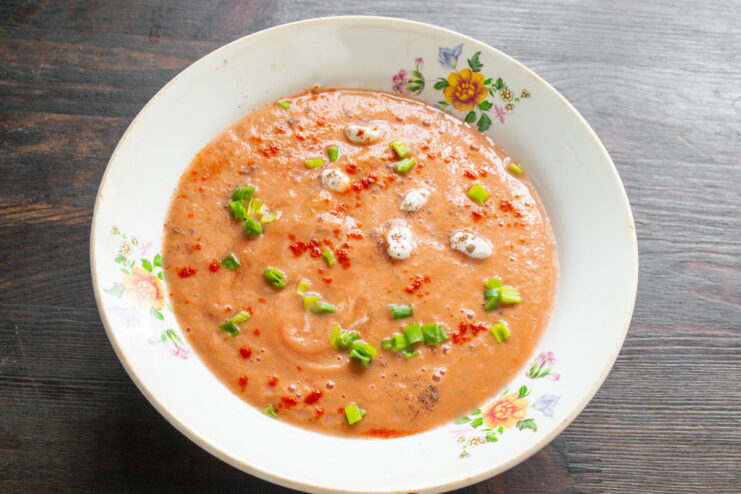 Serving Suggestions for a Perfect Bowl of Gazpacho A finished bowl of gazpacho served cold, with suggestions of toasted bread and a boiled egg.