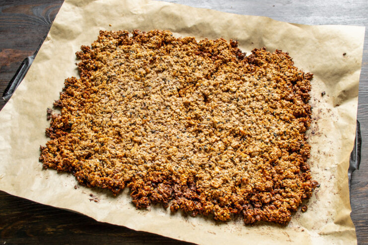 Baking the Granola to Golden-Brown Perfection The baking sheet with granola inside an oven, baking until golden brown.