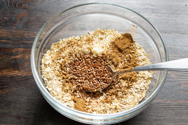Boosting Nutrition with Flax Seeds Pouring flax seeds into the bowl with other granola ingredients.