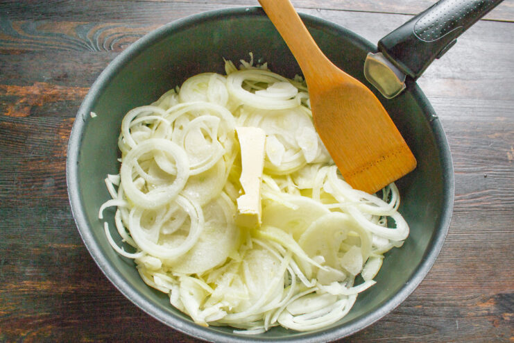 A close-up of finely chopped onions on a cutting board.
