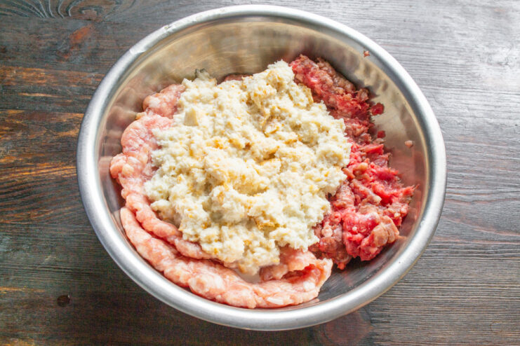 A bowl containing a mixture of ground pork and beef.
