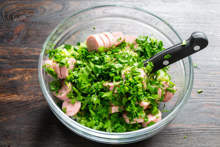 Enhancing the flavor with fresh herbs like parsley and dill. Adding a mix of chopped fresh herbs to the bowl of soup ingredients.
