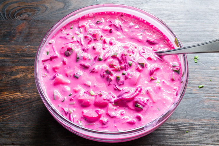 Chilling the soup to let the flavors meld and the color develop. A large bowl of mixed Kholodnik soup, now a vibrant pink color, ready to be chilled.