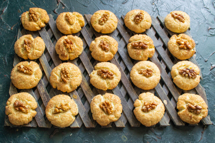 Cooling freshly baked walnut cookies Freshly baked golden-brown walnut cookies cooling on a wire rack.