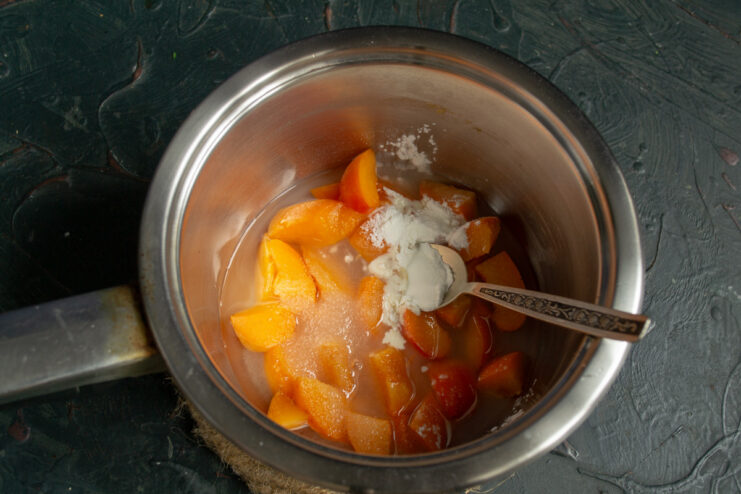 Step 8: Making the apricot or peach fruit sauce Chopped apricots, sugar, and cornstarch in a saucepan for the sauce.