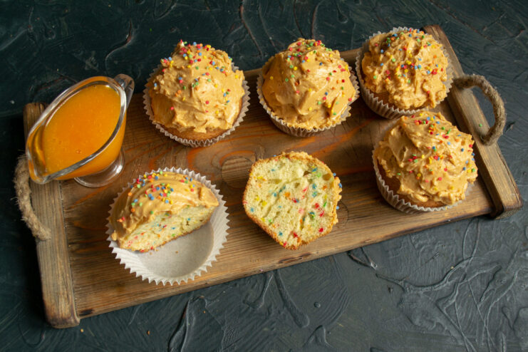 Enjoy these delightful confetti cupcakes with a cup of tea A finished confetti cupcake on a plate, ready to be served with tea.