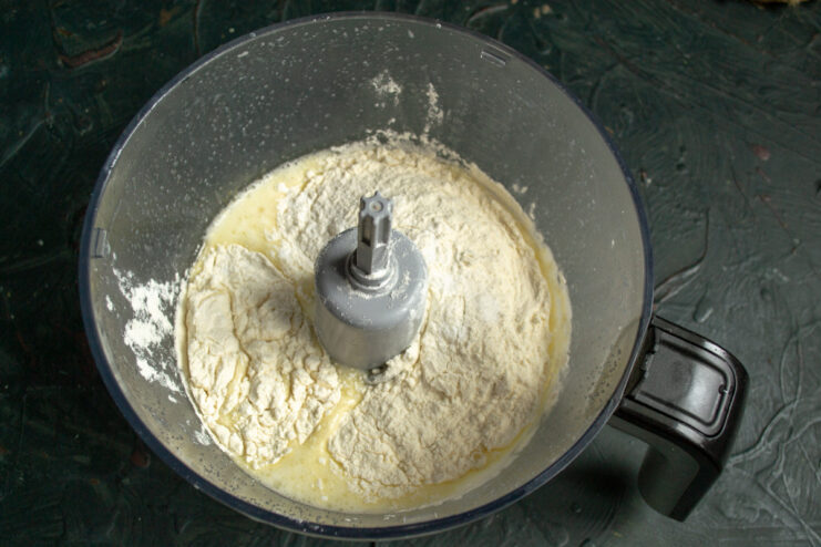 Step 4: Sifting flour into the wet ingredients Adding all-purpose flour to the cupcake batter in a bowl.