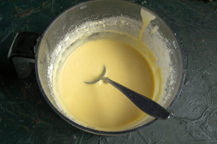 The final consistency of the confetti cupcake batter A bowl of smooth, runny cupcake batter ready for the sprinkles.