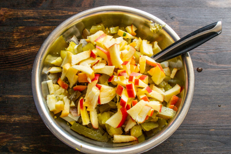Step 6: Adding a touch of sweetness with diced apple Adding diced sweet apple to the salad bowl.