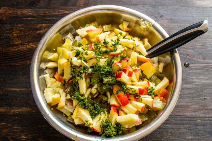 Step 7: Preparing fresh dill for the salad Finely chopping fresh dill on a cutting board.
