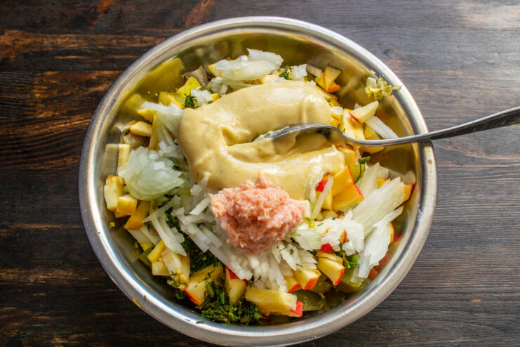 Step 9: Making the creamy and zesty dressing Adding mayonnaise and horseradish paste to the salad ingredients.