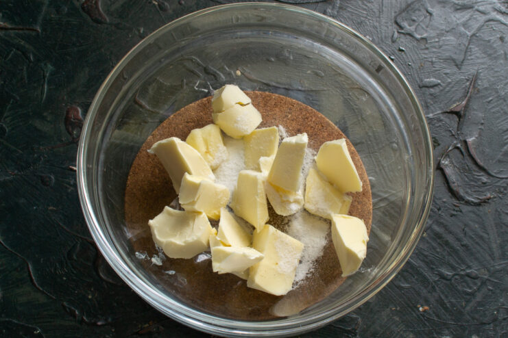 First step: preparing the butter for the cream base. A bowl with cubes of softened butter, ready for mixing.