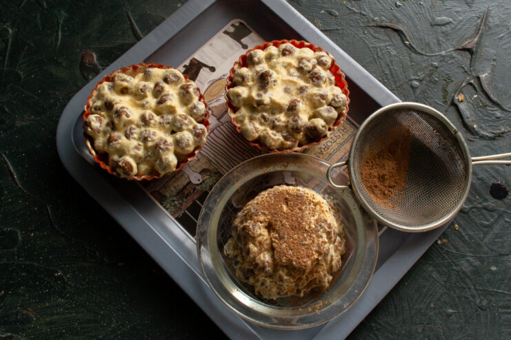 The final touch: dusting the chilled muffins with cocoa powder. Dusting the finished no-bake muffins with cocoa powder using a small sieve.