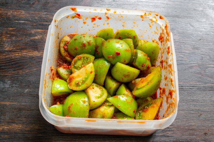 Fermenting Green Tomato Kimchi A sealed container of green tomato kimchi fermenting in a cool, dark place.